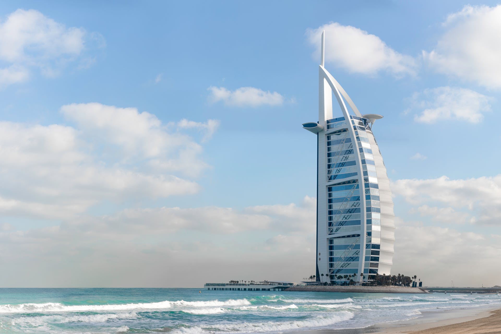 Resembling the ship’s sail, the Burj Al Arab looks like it could be a superhero or villain’s headquarters. In reality, though, the building is a hotel that anybody can stay in - for the right price. While sail-shaped skyscrapers aren’t anything new, what makes this one stand out, in particular, is where it’s located. Unlike most other skyscrapers in the city, the Burj Al Arab is situated right by the sea, sitting on its own human-made islands. Human-made islands aren’t anything new in Dubai, but having one with only a hotel in it is quite the sight to behold. It also helps that the colors of the tower match perfectly with the sea and sky.