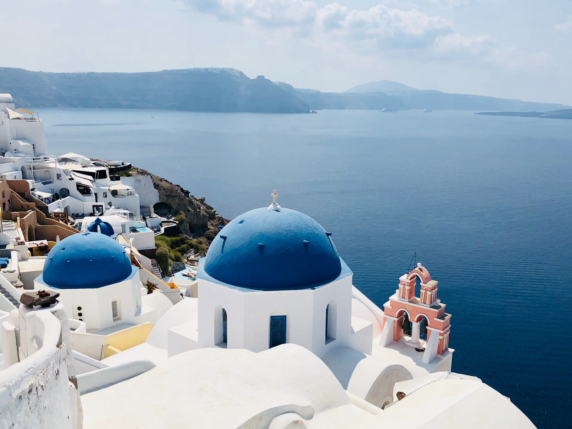Many of the churches on Santorini fit in with the other buildings. They are white with blue domes, the same blue as all the other buildings. When you take your Santorini pictures, remember to get one or more with the blue domes set against the blue of the Aegean. Postcards of Santorini often show these two churches in Oia which sit on the cliff edge.